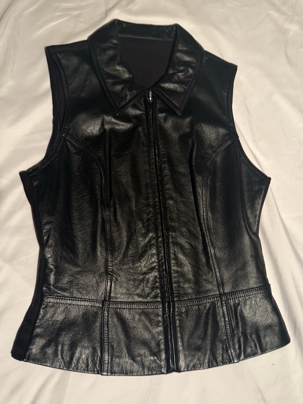 Wilsons Leather Black Sleeveless Zip-Up Leather Vest with stretchy fabric back.